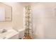 Bathroom features a toilet, shower with white tile, and single sink vanity at 5028 Oxford N Ave, St Petersburg, FL 33710
