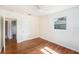 Bedroom features hardwood floors, neutral paint, ceiling fan, and natural light from one window at 5028 Oxford N Ave, St Petersburg, FL 33710
