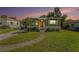 Charming single-story home with well-maintained lawn, mature tree, and inviting front entrance at 5028 Oxford N Ave, St Petersburg, FL 33710