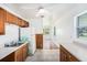 Cozy kitchen area featuring wood cabinets, tile flooring, and ample natural light at 5028 Oxford N Ave, St Petersburg, FL 33710