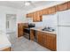 Functional kitchen with wood cabinets, stainless steel appliances, and tile flooring at 5028 Oxford N Ave, St Petersburg, FL 33710