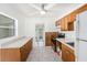 Bright kitchen with wooden cabinets, a stainless steel range, and durable tile flooring at 5028 Oxford N Ave, St Petersburg, FL 33710