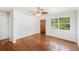 Open living room featuring hardwood floors, a ceiling fan, and natural light from the window at 5028 Oxford N Ave, St Petersburg, FL 33710