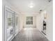 Bright sunroom with tile flooring, large windows, and access to the outside at 5028 Oxford N Ave, St Petersburg, FL 33710
