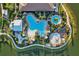 Aerial view of resort style swimming pools, splash pad, and hot tub surrounded by beautiful landscaping at 5364 Salcano St, Sarasota, FL 34238