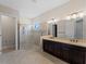 Spacious bathroom features a glass-enclosed shower, dual sinks, and contemporary fixtures for a luxurious experience at 5364 Salcano St, Sarasota, FL 34238