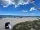 Scenic beach scene with a lifeguard vehicle on the sand, people enjoying the beach, and clear blue skies above at 5364 Salcano St, Sarasota, FL 34238