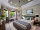Serene bedroom boasts a large bed, soft lighting, and views of the outdoors, offering a peaceful retreat at 5364 Salcano St, Sarasota, FL 34238