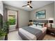 Comfortable bedroom with ceiling fan features a decorative painting and two bedside tables on each side of the bed at 5364 Salcano St, Sarasota, FL 34238