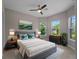 Bright bedroom with natural light, ceiling fan, decorative pillows and bedside tables on each side of the bed at 5364 Salcano St, Sarasota, FL 34238