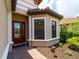 Inviting front entrance with a decorative glass door, brick walkway, and manicured landscaping at 5364 Salcano St, Sarasota, FL 34238