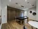 Entertaining game room featuring a stylish ping pong table, modern lighting, and hardwood floors for leisure and fun at 5364 Salcano St, Sarasota, FL 34238