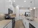 Modern kitchen equipped with stainless steel appliances, granite countertops, and ample cabinet space at 5364 Salcano St, Sarasota, FL 34238