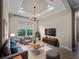Cozy living room features neutral tones, plush seating, and modern lighting fixtures, creating a relaxing atmosphere at 5364 Salcano St, Sarasota, FL 34238