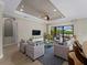 Living room featuring tray ceiling, recessed lighting, and access to the outdoor living area at 5364 Salcano St, Sarasota, FL 34238
