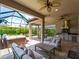 Screened outdoor living area with a hot tub, outdoor kitchen, and comfortable seating at 5364 Salcano St, Sarasota, FL 34238