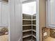 Walk-in pantry with custom shelving provides ample storage space for all your kitchen essentials at 5364 Salcano St, Sarasota, FL 34238