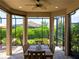Screened-in lanai with seating for six perfect for entertaining overlooking the lush landscaping at 5364 Salcano St, Sarasota, FL 34238