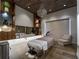 Relaxing spa room with massage table, modern decor, and wood-look tile flooring at 5364 Salcano St, Sarasota, FL 34238