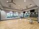 Bright exercise studio with hardwood floors, wall mirrors, and ample space for fitness and wellness activities at 5364 Salcano St, Sarasota, FL 34238