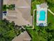 Aerial view of a home with a private pool, lush landscaping, and a tile roof at 5417 Champagne # 63, Sarasota, FL 34235