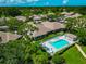Aerial view of community featuring serene pool, lush landscaping, and well-maintained homes at 5417 Champagne # 63, Sarasota, FL 34235