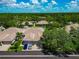 An aerial view of the residential neighborhood featuring beautiful, mature trees, and well maintained homes at 5417 Champagne # 63, Sarasota, FL 34235