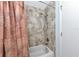 Bathroom with a tub and shower featuring patterned tiling and shower curtain at 5417 Champagne # 63, Sarasota, FL 34235