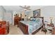 Inviting bedroom features a ceiling fan, a plush bed with patterned bedding and elegant furniture set at 5417 Champagne # 63, Sarasota, FL 34235
