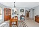 Warm dining room with wooden furniture, area rug and access to hallway and open kitchen at 5417 Champagne # 63, Sarasota, FL 34235