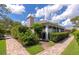 Lovely home featuring manicured landscaping, chimney, and a screened in patio area at 5417 Champagne # 63, Sarasota, FL 34235