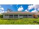 Landscaped exterior featuring well manicured bushes, a large lanai and a chimney at 5417 Champagne # 63, Sarasota, FL 34235