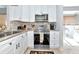 Modern kitchen with stainless steel appliances, tile floors, and access to a bright outdoor patio at 5417 Champagne # 63, Sarasota, FL 34235