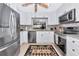 Modern kitchen with stainless steel appliances, white cabinets, and open view to the dining area at 5417 Champagne # 63, Sarasota, FL 34235