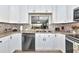 Updated kitchen showcasing stainless steel appliances, stone countertops, and a tiled backsplash at 5417 Champagne # 63, Sarasota, FL 34235
