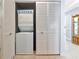 Convenient laundry closet featuring a stacked washer and dryer for efficient space saving at 5417 Champagne # 63, Sarasota, FL 34235