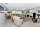 Spacious living room features a large sofa, fireplace, built-in shelving, and plenty of natural light at 5417 Champagne # 63, Sarasota, FL 34235