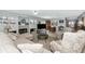 Open-concept living room featuring a fireplace, built-ins, and seamless flow to dining area at 5417 Champagne # 63, Sarasota, FL 34235