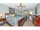 Relaxing main bedroom with a decorative ceiling fan, en-suite bath, and patio access at 5417 Champagne # 63, Sarasota, FL 34235