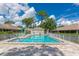 Community pool with clear water, surrounded by a fence and lounge chairs under sunny skies at 5417 Champagne # 63, Sarasota, FL 34235