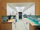 Well-lit kitchen with white cabinets, tiled backsplash, butcher block countertops, and modern appliances at 555 The Esplanade N # 202, Venice, FL 34285