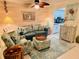 Cozy living room with decorative coastal accents, comfortable seating, and an adjacent kitchen area at 555 The Esplanade N # 202, Venice, FL 34285