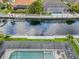 Aerial view of a screened pool with spa overlooking deep canal water at 584 Mast Dr, Bradenton, FL 34208