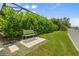 Backyard showing green bench near lush landscaping and green grass at 584 Mast Dr, Bradenton, FL 34208