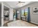 Bedroom with designer rug, patio access, work space and ensuite bathroom at 584 Mast Dr, Bradenton, FL 34208