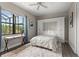 Bright bedroom features a Murphy bed with built-ins, a modern desk by the window, and a soft rug at 584 Mast Dr, Bradenton, FL 34208