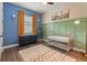Bedroom with custom green trim, designer rug, blue accent wall and modern lighting at 584 Mast Dr, Bradenton, FL 34208