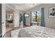 Bedroom with designer rug, patio access, work space and ensuite bathroom at 584 Mast Dr, Bradenton, FL 34208