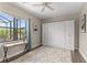 Bright bedroom with a Murphy bed, a modern desk, a soft rug, and view to the screened outdoor area at 584 Mast Dr, Bradenton, FL 34208
