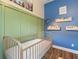 Bedroom featuring a blue accent wall, green trim and custom book shelves at 584 Mast Dr, Bradenton, FL 34208